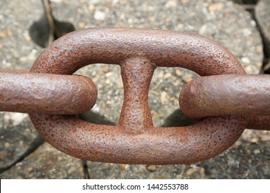 chain for ship's anchor Close up on a Sidewalk tiles background, metal chain for boats, ships anchor chain on the floor