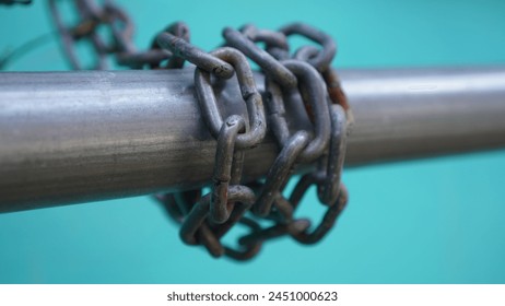 A chain that was quite large and long enough was wrapped around an iron pipe behind the house belonging to his mother's older sister - Powered by Shutterstock