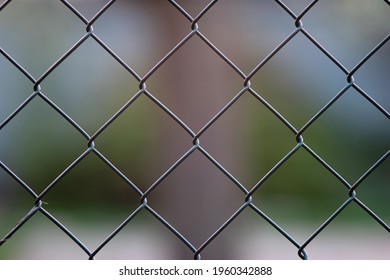 Chain wire mesh fence links macro close up shot shallow depth of field.