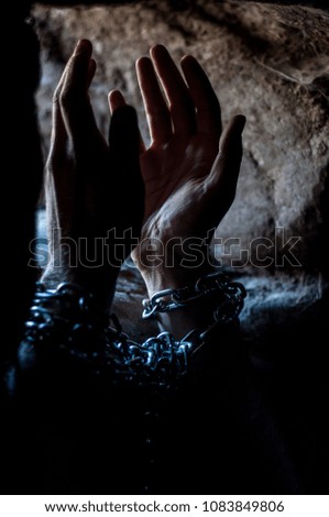 Chained prisoner is praying