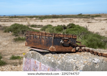 Chained rusty metal case in Dungeness
