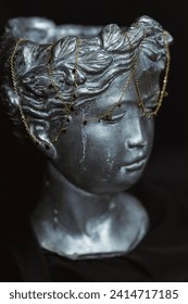 Chains on the head of a bronze sculpture