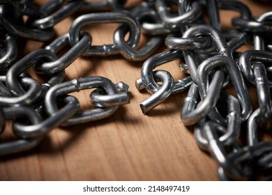 Chains Are Only As Strong As Their Weakest Links. Shot Of Metal Chains With A Broken Link.