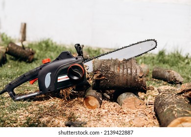 Chainsaw close up. Chainsaw with a tool. Chainsaw on the background of firewood