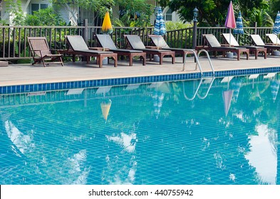 chair around swimming pool in hotel resort