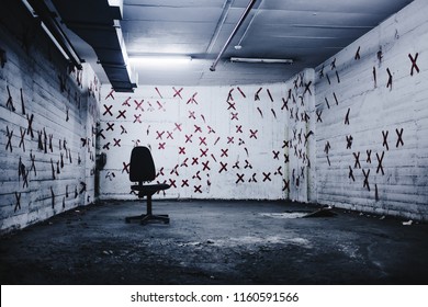 chair in an empty abandoned gloomy terrible room with red crosses on the walls