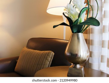 Chair And End Table With Flowers By The Window.