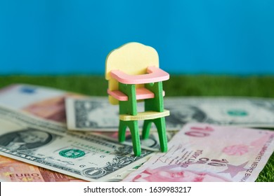 A Chair For Feeding Children Costs Money. Conceptual Photo, Cost Of Maintaining A Child, Expenses For Raising Food, Clothing And Education.