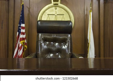 Chair Of Judge And Flags In Empty Courtroom