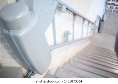 Chair Lift For Disabled And Elderly People At Library Stairs. Libraries And Disability Concept