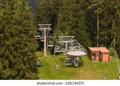 Chair Lift - The Most Common And Easiest Way To Reach The Top Of The Mountain.Chairlift In Summer - The Base With Operator At The Top Of The Mountain.