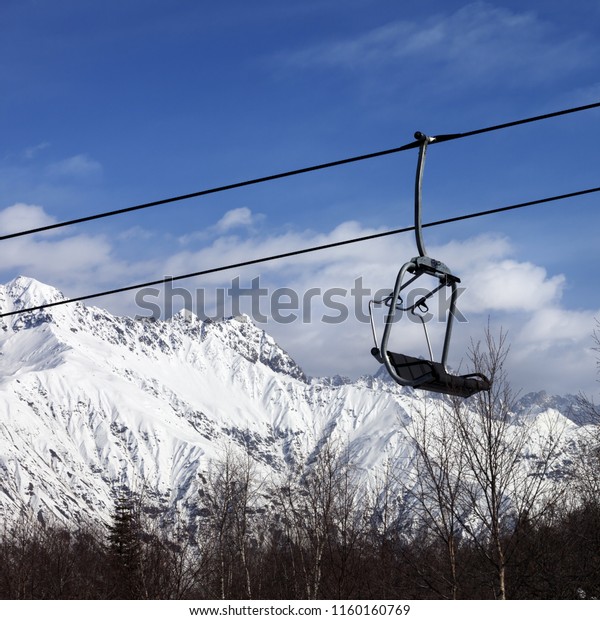 Chair\
lift in snowy mountains at nice day. Caucasus Mountains. Hatsvali,\
Svaneti region of Georgia in winter. Square\
image.