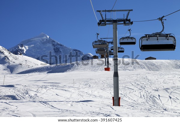 Chair lift in\
snowy mountains at nice sunny day. Caucasus Mountains. Mount\
Tetnuldi, Svaneti region of\
Georgia.