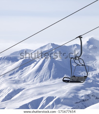 Chair lifts and off piste slope in fog. Caucasus Mountains, Georgia, ski resort Gudauri.