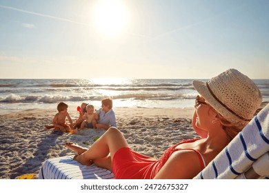 Chair, relax or family with woman at beach on holiday vacation or weekend together with dad or children. Father, calm mother or kids siblings at sea for bonding or break in nature in Spain in summer - Powered by Shutterstock