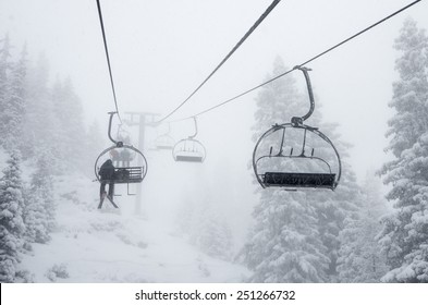 Chair Ski Lift In Misty Snowy Alpine Forest In Chamonix, French Alps - Enigmatic Winter Background 