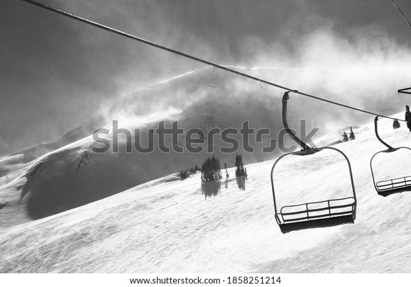 Chairlift and\
blowing snow at the continental\
divide.