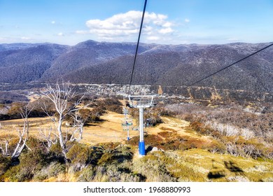 Chairlift Cableway Down To THredbo Village From Hights Of SNowy Mountains In Australia - Sunny Autumn Day.