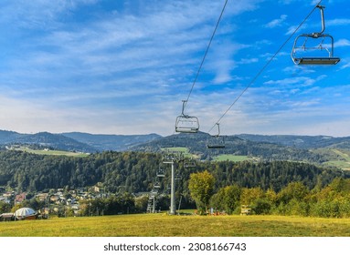 Chairlift in Wisła Nowa Osada in Silesian Beskid (Poland) on a sunny autumn day.