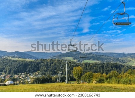 Chairlift in Wisła Nowa Osada in Silesian Beskid (Poland) on a sunny autumn day.
