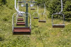 Chairlift Ski Lift In European Alps. Transporting Hikers In Summer Season.