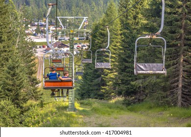 Chairlift ski lift in European Alps leading to mountain station. Transporting hikers in summer season.