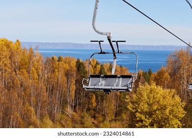 Chairlift to the top of the mountain. Beautiful autumn landscape. Ski resort by the lake. - Powered by Shutterstock