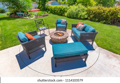 Chairs around a circular fire pit in the backyard