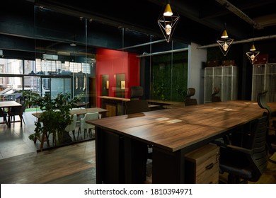 Chairs And Desks Sitting Empty In The Work Area Of A Large Modern Office Space After Business Hours