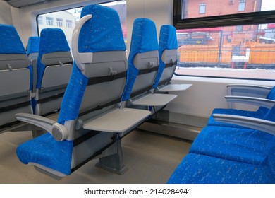 Chairs with folding tables in public transport. Seats in the commuter train. - Shutterstock ID 2140284941