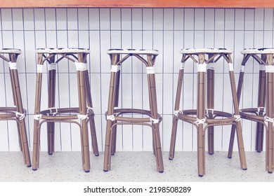 Chairs Made Of Rattan Line Up In Front Of The Bar.