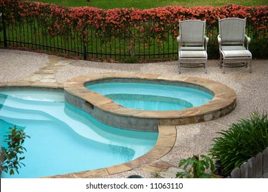 Chairs On Deck Besides Swimming Pool In Back Yard