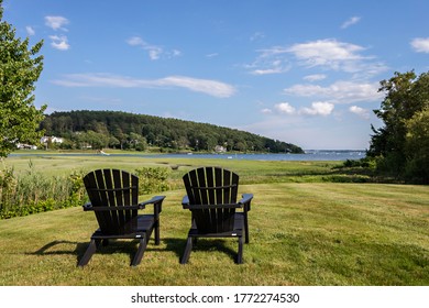Chairs on lawn overlooking water - Shutterstock ID 1772274530