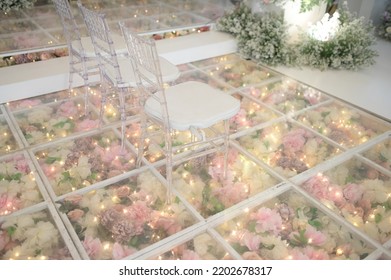 Chairs On Top Of Clear Acrylic Floors With Flowers Decoration Below See Through