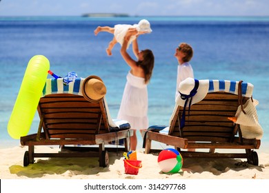 chairs on tropical beach, family beach vacation concept