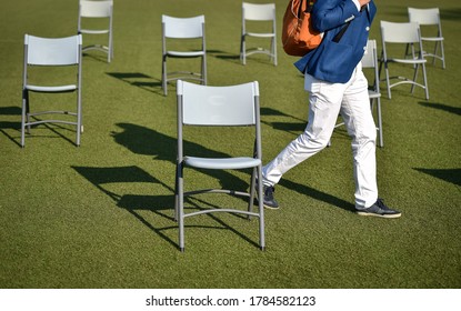 Chairs On The Turf Of A Soccer Field Maintaining The Social Distance Imposed By Corona Virus Restrictions During An Event