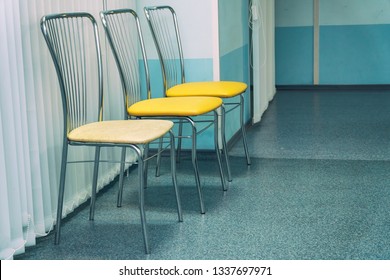 Chairs stand in a row in the waiting hall or corridor - Shutterstock ID 1337697971