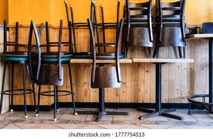 Chairs and Stools Stacked on Tables in an Empty Closed Restaurant during Covid-19 Pandemic - Shutterstock ID 1777754513