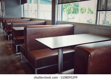 Chairs and table in the empty restaurant.brown sofas with tables.