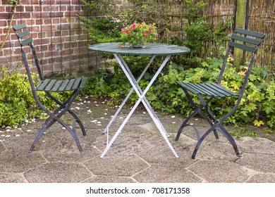 Chairs And Table In The Garden Of An Idyllic Rural Cottage House, Denmark.