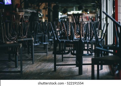 Chairs and tables stacked in a closed pub - Shutterstock ID 522191554