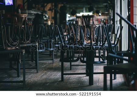 Chairs and tables stacked in a closed pub