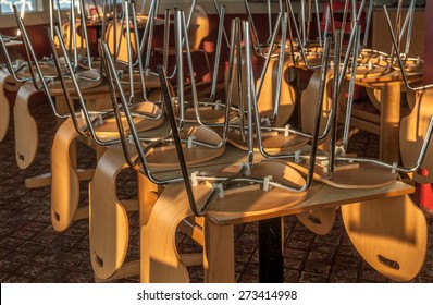 Chairs And Tables Stacked In A Closed Restaurant.