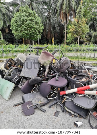 chairs that have been used and damaged and stored in a special place for disposal