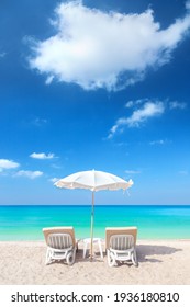 Chairs And Umbrella On The Beach