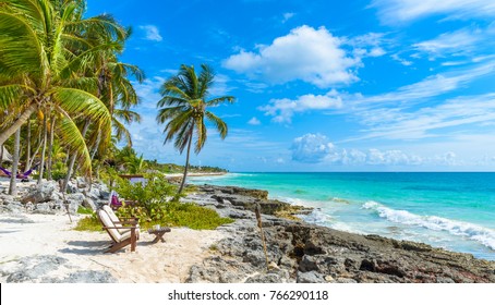 Chairs Under The Palm Trees On Paradise Beach At Tropical Resort. Riviera Maya - Caribbean Coast At Tulum In Quintana Roo, Mexico