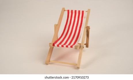 Chaise Lounge Chair With Red Stripes For Relaxing.