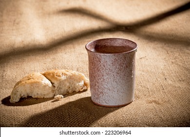 chalice and bread on the textile tablecloth