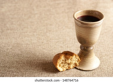 Chalice with wine and bread. Background with copy space