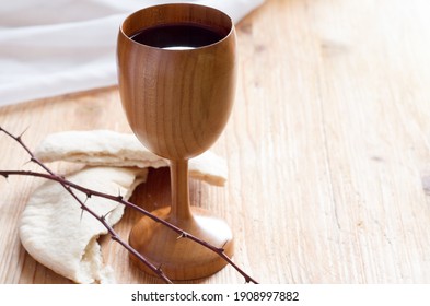 Chalice of wine, passover bread, thorns as Jesus Last Supper and Passion of Christ concept